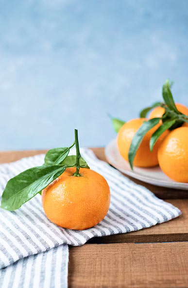 Orange Fruit on White Table Cloth